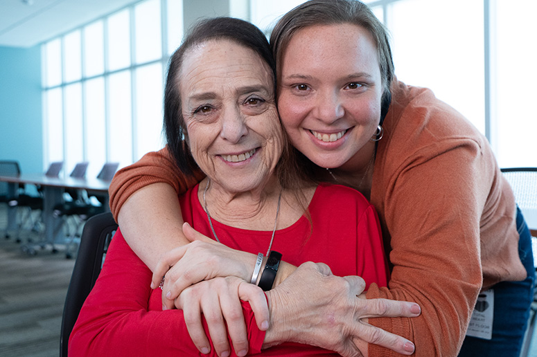 Jan, being pushed in her wheelchair by her daughter
