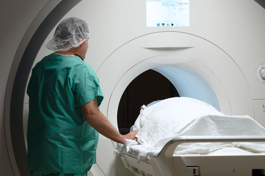 A specialist performing a scan on a neurology patient